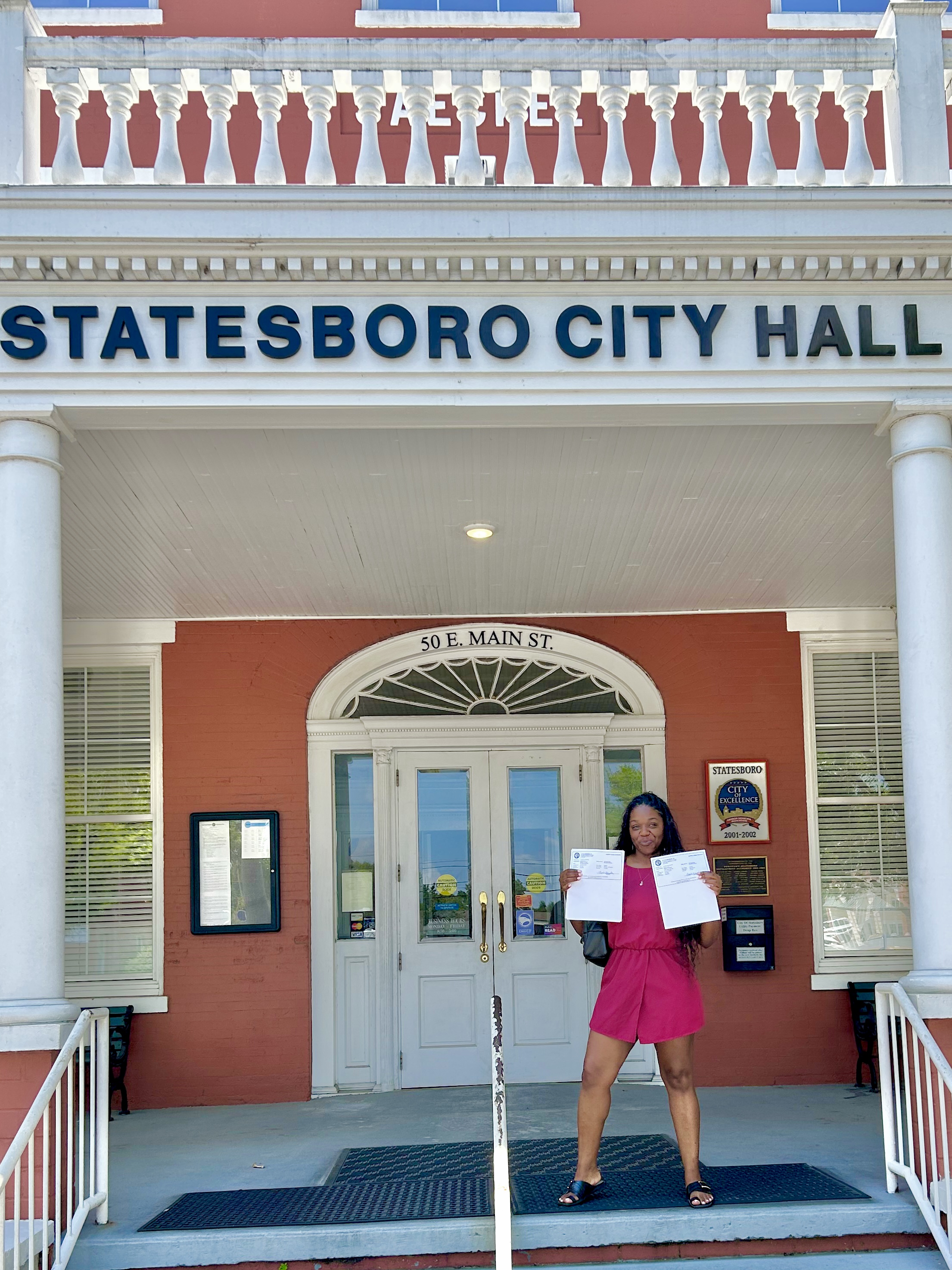 Samere Bey at Statesboro City Hall with establishment documents