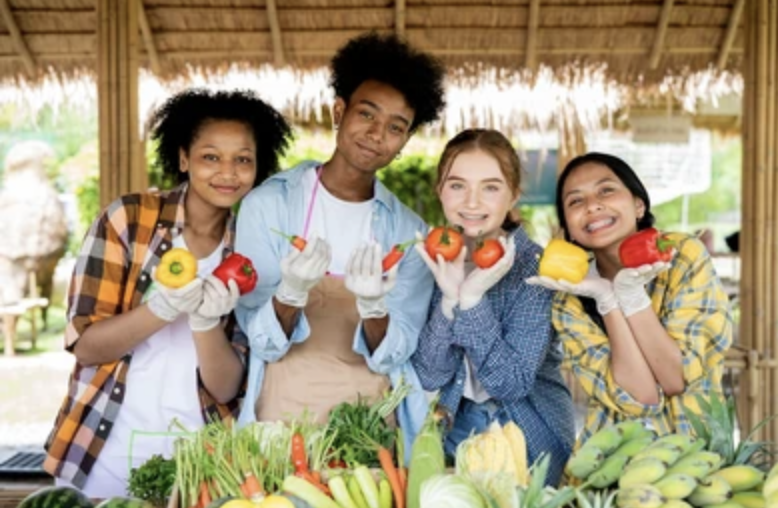 Young entrepreneurs selling produce and handmade goods at Youth United